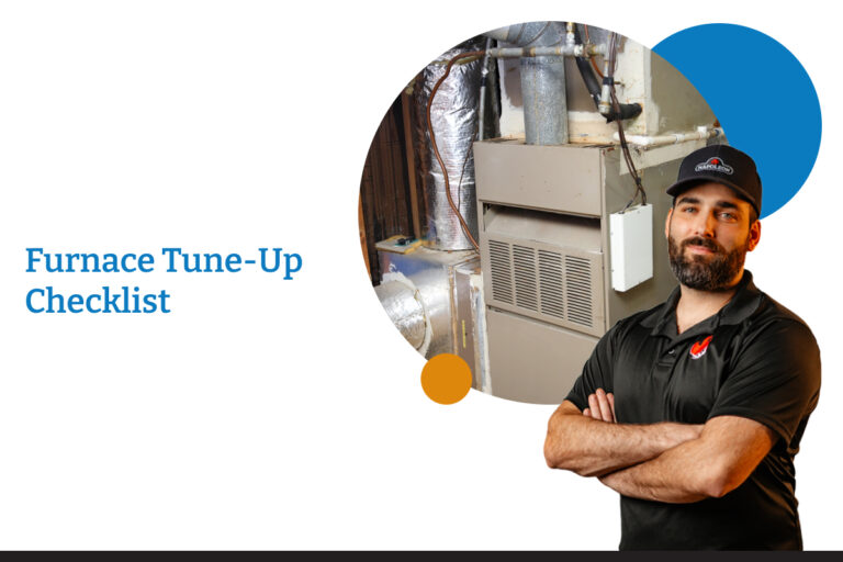 A repairman stands proudly beside an old furnace. Winnipeg Duct cleaning is ready to tune up your furnace.